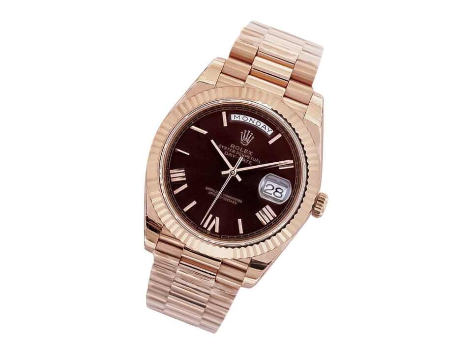 Day-Date 40 Rose Gold 'President' watch with chocolate dial, Roman numerals, and fluted bezel displayed at an angle.
