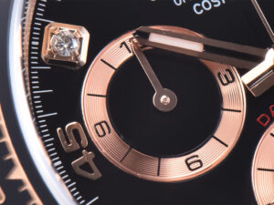 Close-up of Daytona Rose Gold watch face featuring a diamond-accented black dial with intricate rose gold detailing.