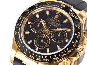 Close-up of Cosmograph Daytona Yellow Gold Oysterflex watch with black dial, gold details, and ceramic bezel.
