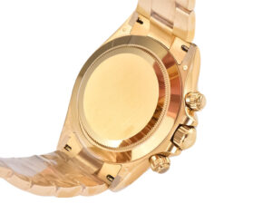 Back view of Cosmograph Daytona Yellow Gold with Black Dial, showcasing the polished gold case and detailed craftsmanship.