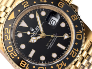 GMT-Master II Yellow Gold watch with black dial, 40mm case, Jubilee bracelet, and luminous markers displayed up close.