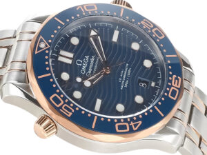Seamaster Diver 300 Two Tone Rose Gold with Blue Dial (42mm) featuring a wave-patterned dial and stainless steel bracelet.