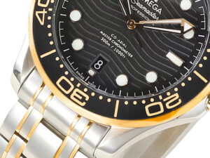 Close-up of the Seamaster Diver 300 Two Tone with black dial, featuring a 42mm case gold accents on its bezel and bracelet.