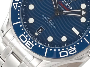 Close-up of Seamaster Diver 300 Stainless Steel, featuring a blue wavy-patterned dial, white markers, silver bracelet (42mm).