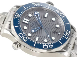 Seamaster Diver 300 Stainless Steel watch with a 42mm silver dial, blue ceramic bezel, and wave pattern design.