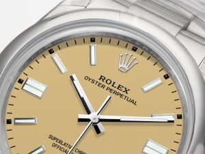 Close-up of Oyster Perpetual 36 Stainless Steel with beige dial, silver markers, and Rolex branding.